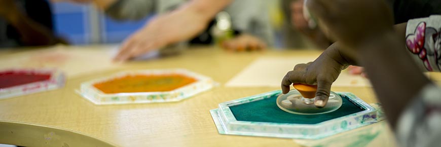 Children work on an art project in Classroom G-1 at the Child Development Center.